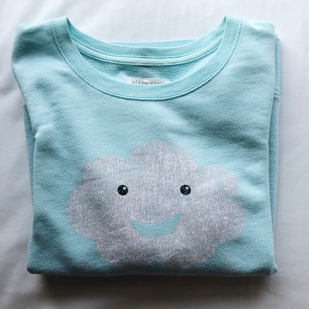A sea foam green/blue crewneck with cloud